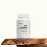 Supplement bottle labeled 'Cell Longevity' on a wooden surface with a white background