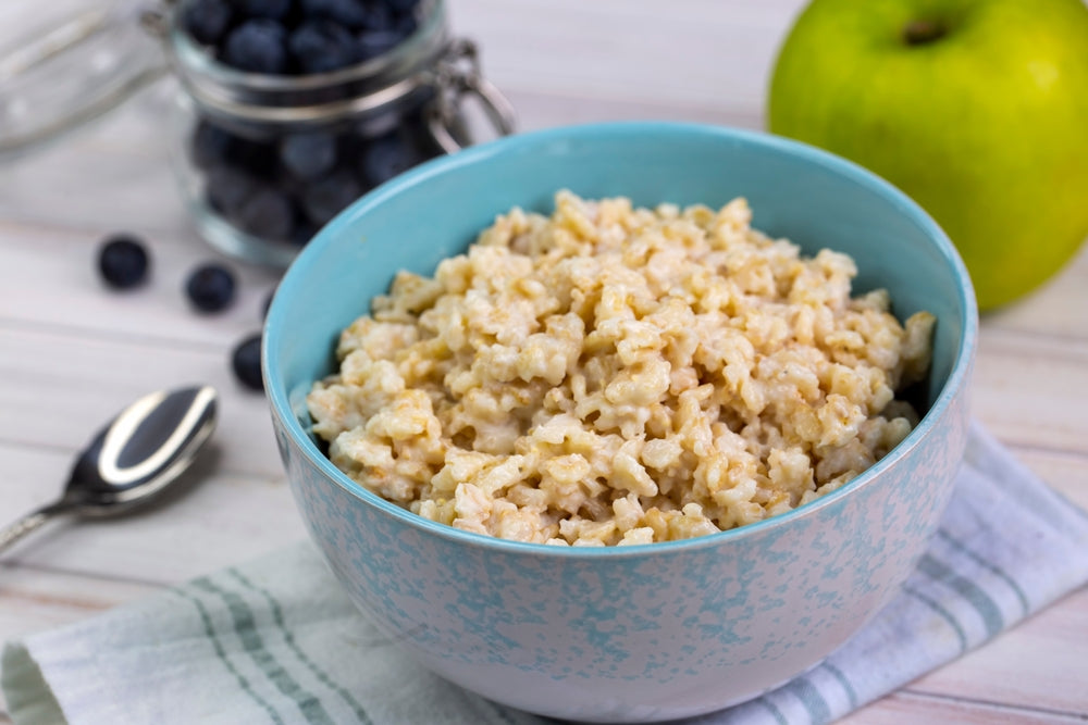 A bowl of oatmeal on a wooden table, illustrating an article on glyphosate in oats.