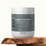 Supplement container labeled 'Acetyl L-Carnitine' by Healthy Goods on a wooden surface with a white background.