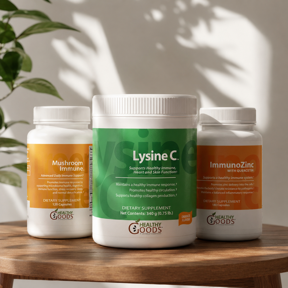 Three supplement bottles on a wooden surface with a plant in the background