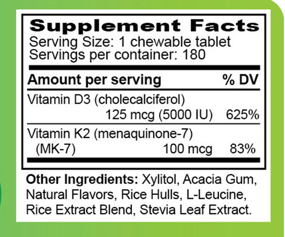 Supplement bottle labeled 'D3+K2' on a wooden surface with a white background