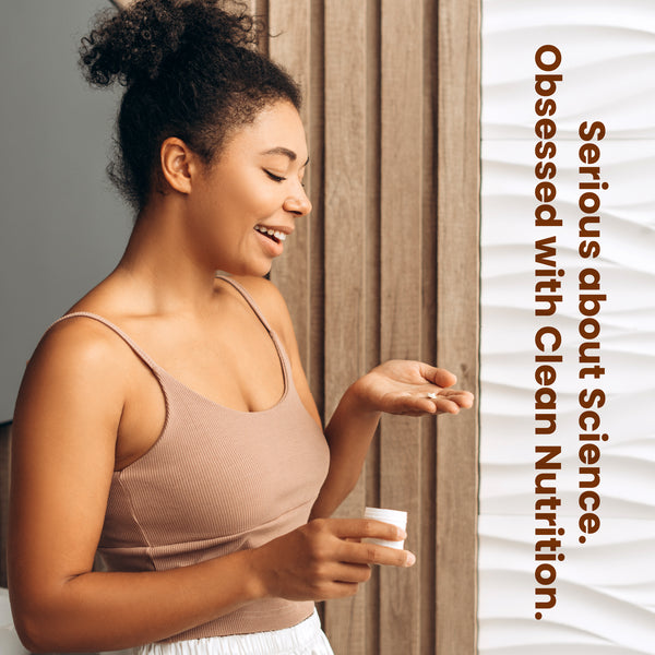 Woman holding a supplement container with text about clean nutrition.