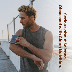 Man holding a smartphone with text 'Obsessed with Clean Nutrition' on a blurred background