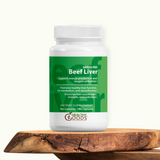 Supplement bottle labeled 'Grass-Fed Beef Liver' on a wooden surface with a white background