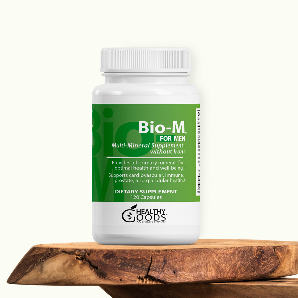 Supplement bottle labeled 'Bio-M for Men' on a wooden surface with a white background