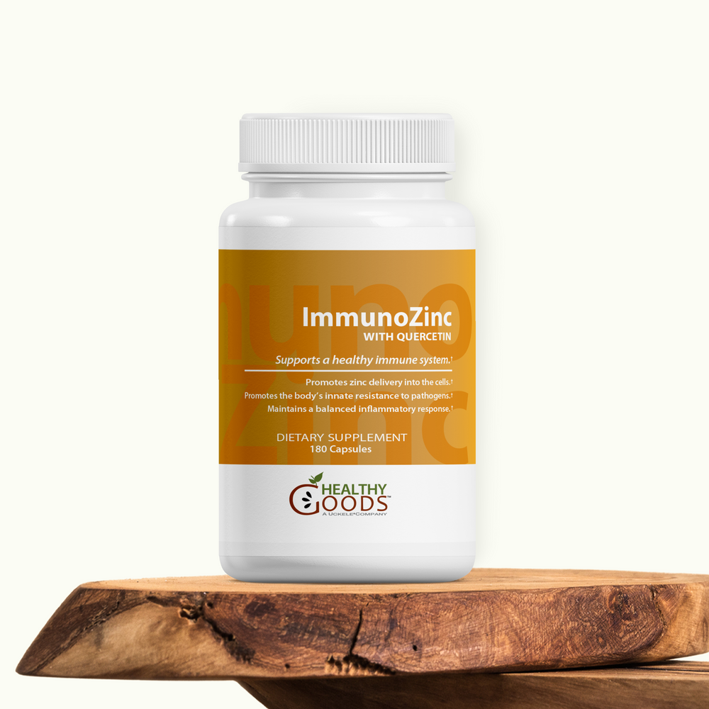 Supplement bottle labeled 'ImmunOZinc' on a wooden surface with a white background