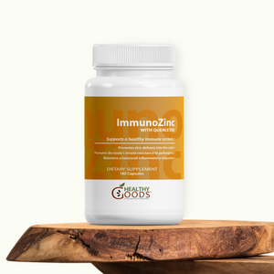 Supplement bottle labeled 'ImmunOZinc' on a wooden surface with a white background