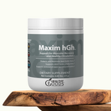 Dietary supplement container labeled 'Maxim hGH' by Healthy Goods on a wooden surface.