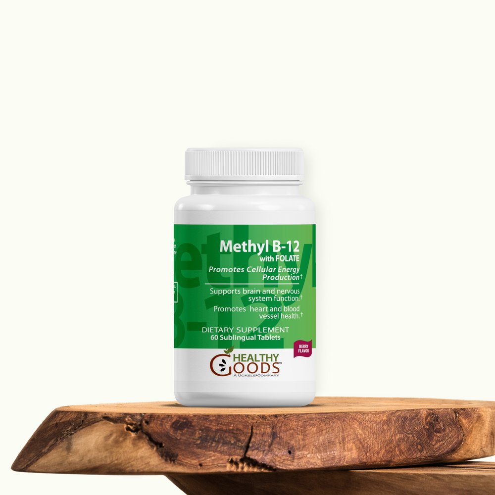 Supplement bottle labeled 'Methyl B-12' on a wooden surface with a white background