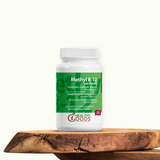 Supplement bottle labeled 'Methyl B-12' on a wooden surface with a white background