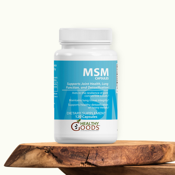 Supplement bottle labeled 'MSM Capsules' by Healthy Goods on a wooden surface with a white background