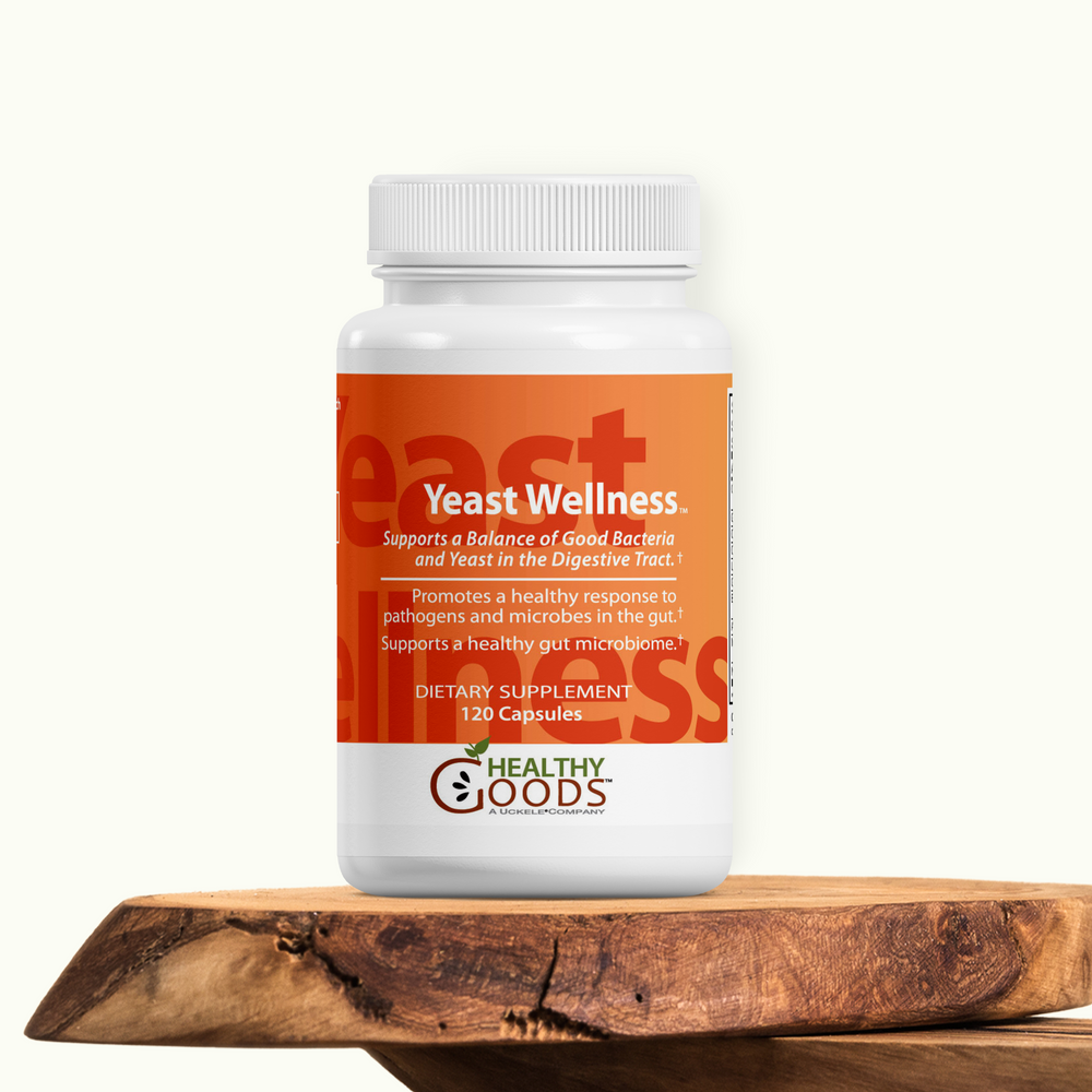 Yeast Wellness supplement bottle on a wooden surface with a white background